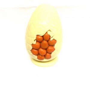 Handmade 5″ white chocolate Easter Egg decorated with orange smartie eggs